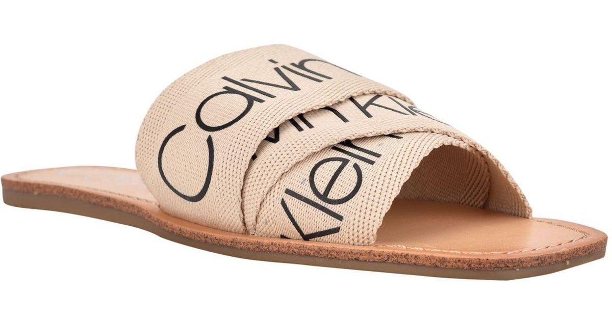 Calvin Klein Bainy Logo Flat Sandals in Natural | Lyst Calvin Klein Bainy Logo Flat Sandals in Natural | Lyst