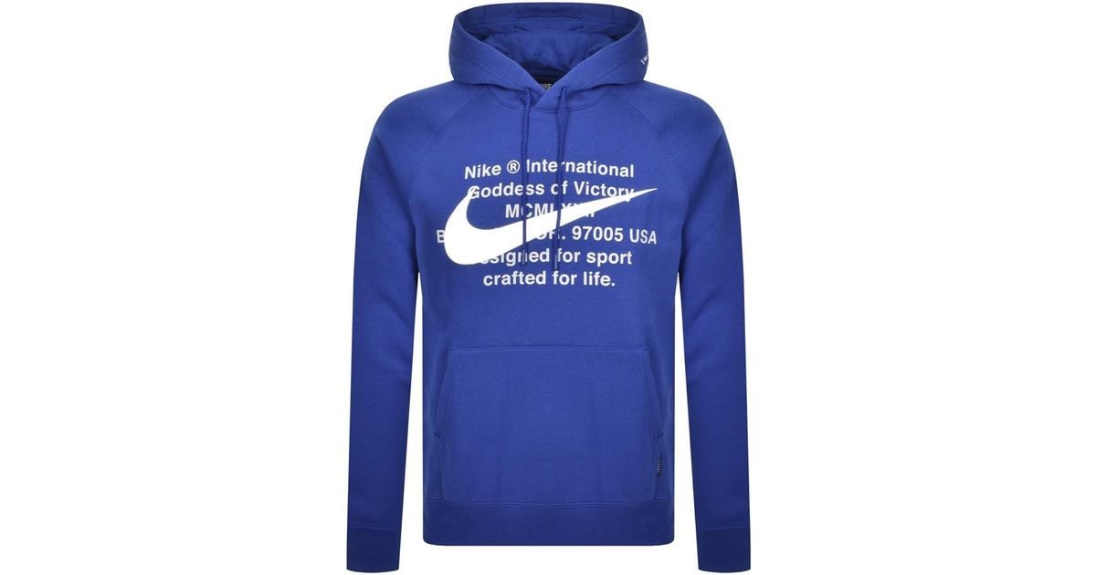 white nike hoodie with blue swoosh