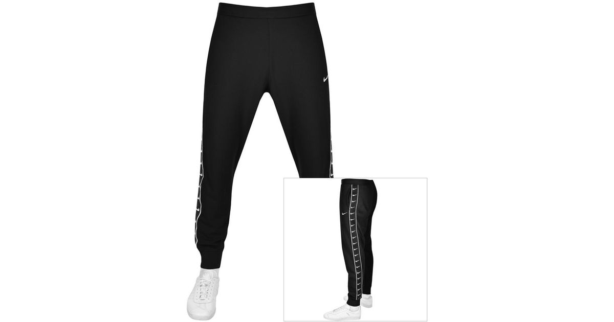 nike graphic outline swoosh cuffed cargo joggers in black