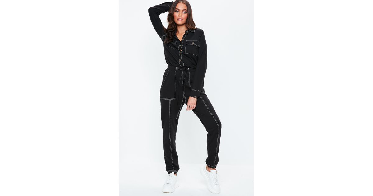 black jumpsuit with white stitching