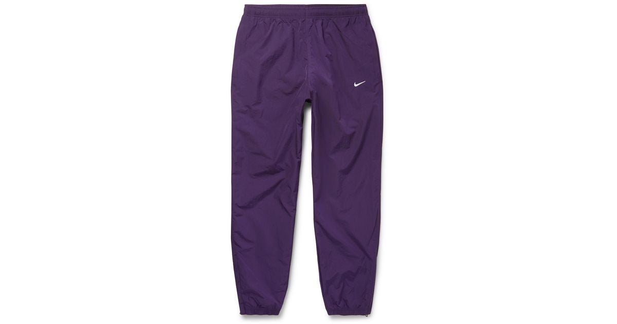 Nike Nrg Tapered Logo-embroidered Shell Track Pants in Purple for
