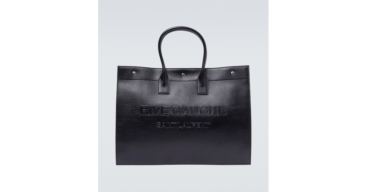 Mens Bags Tote bags Saint Laurent Rive Gauche-debossed Leather Tote Bag in Black for Men 
