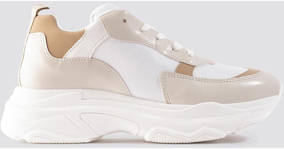 nude and white trainers