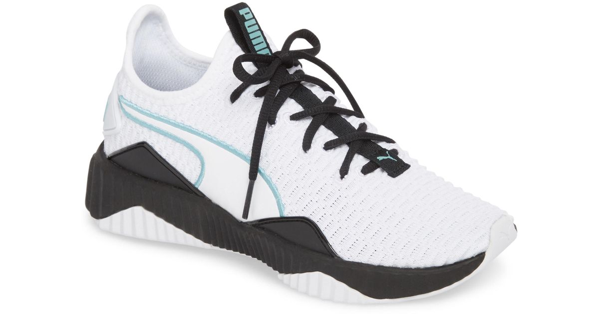 puma defy sneakers in white