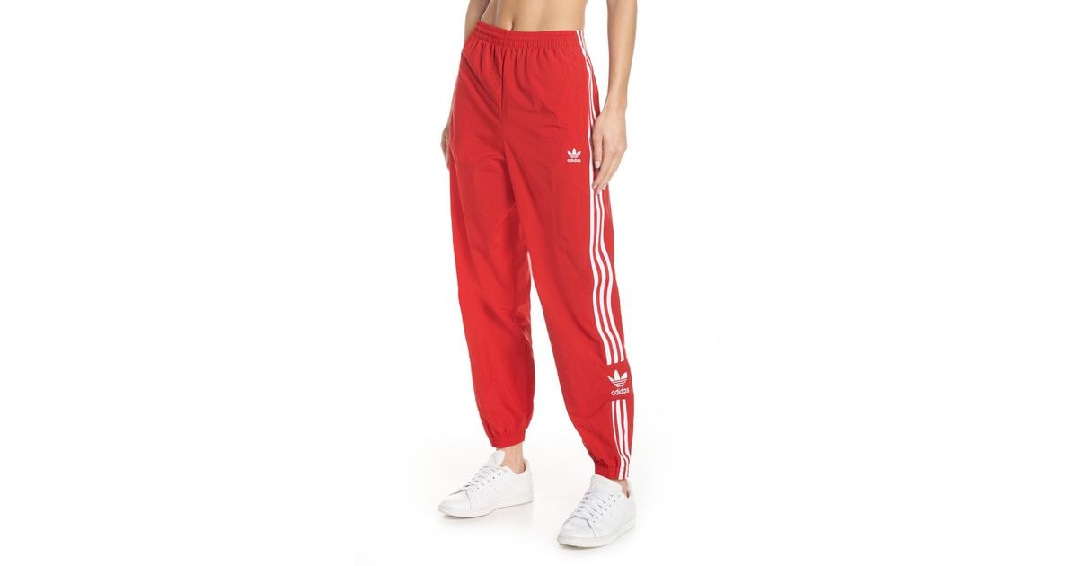 adidas originals adicolor locked up logo track pants in red