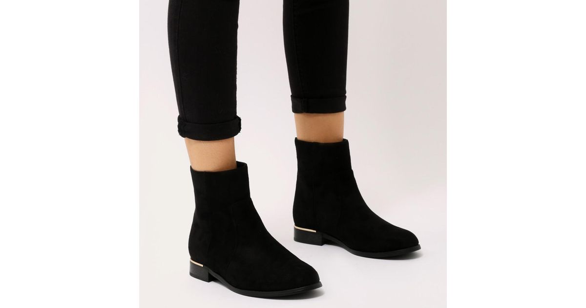 black boots with gold trim