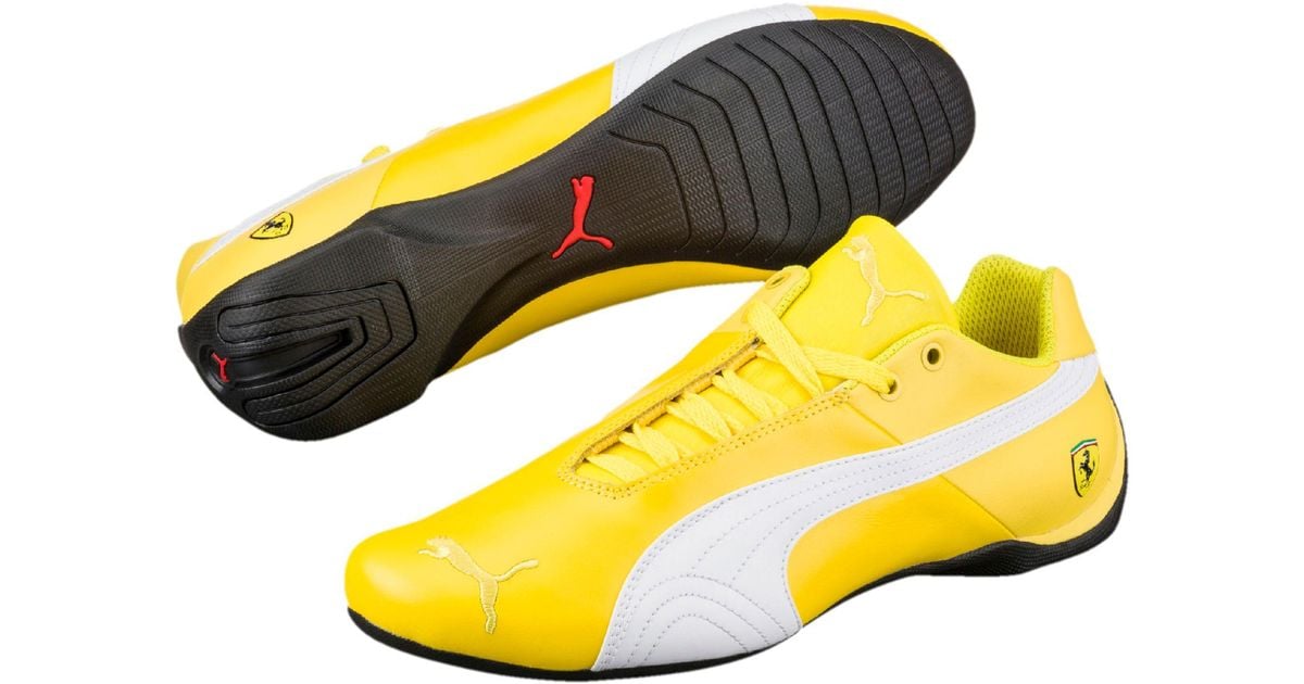 yellow and white puma shoes