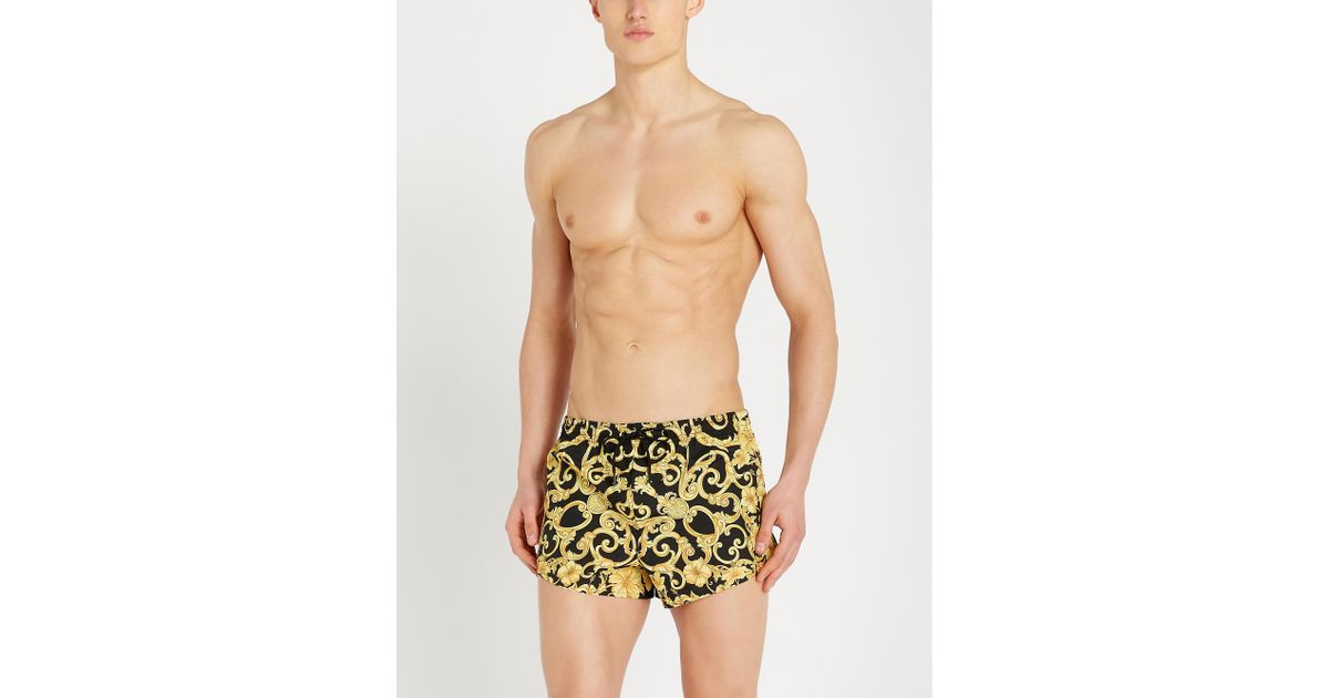 gold hibiscus print swim shorts