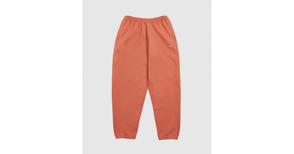 orange nike pants