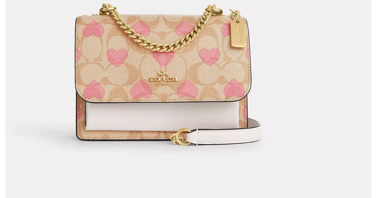 COACH Mini Klare Crossbody In Signature Canvas With Heart Print in Pink