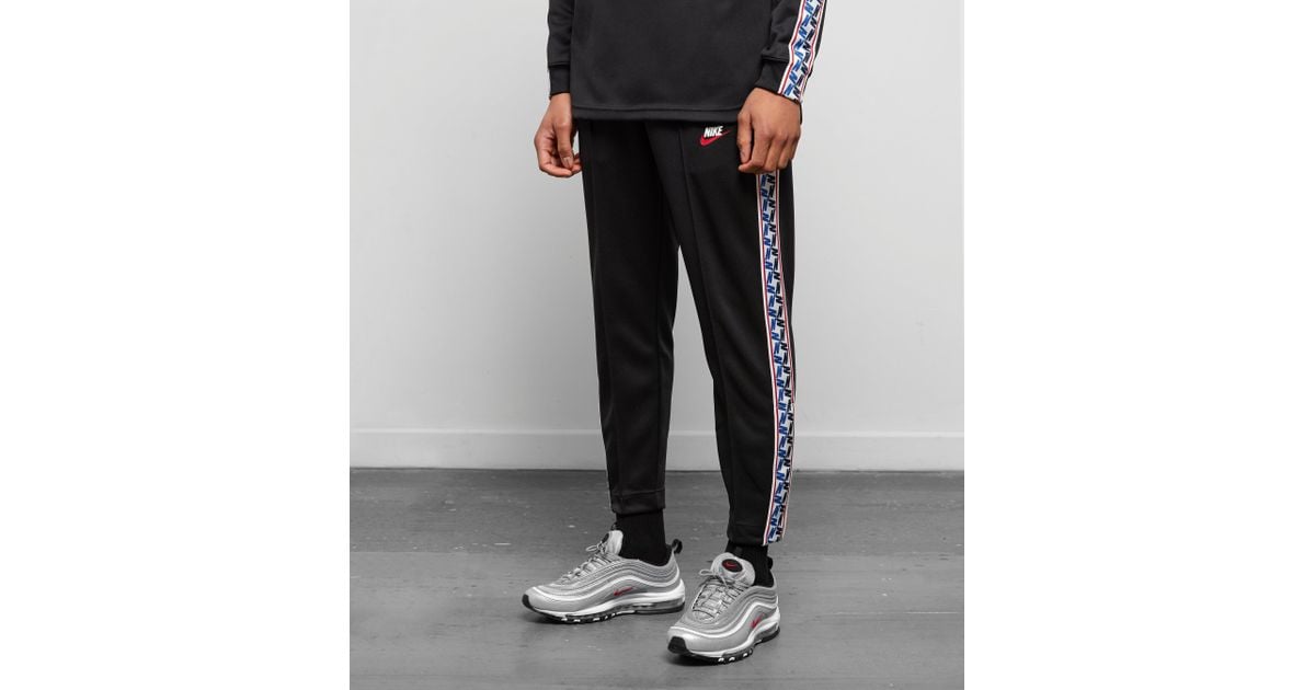 nike taped poly track pants