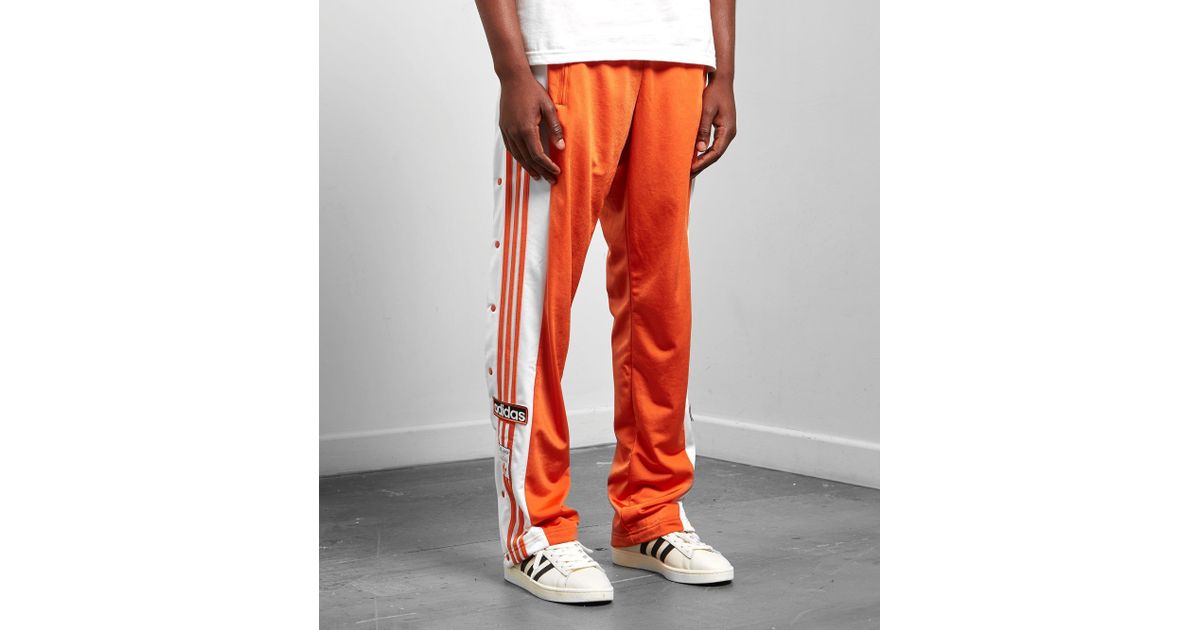 adibreak track pants orange