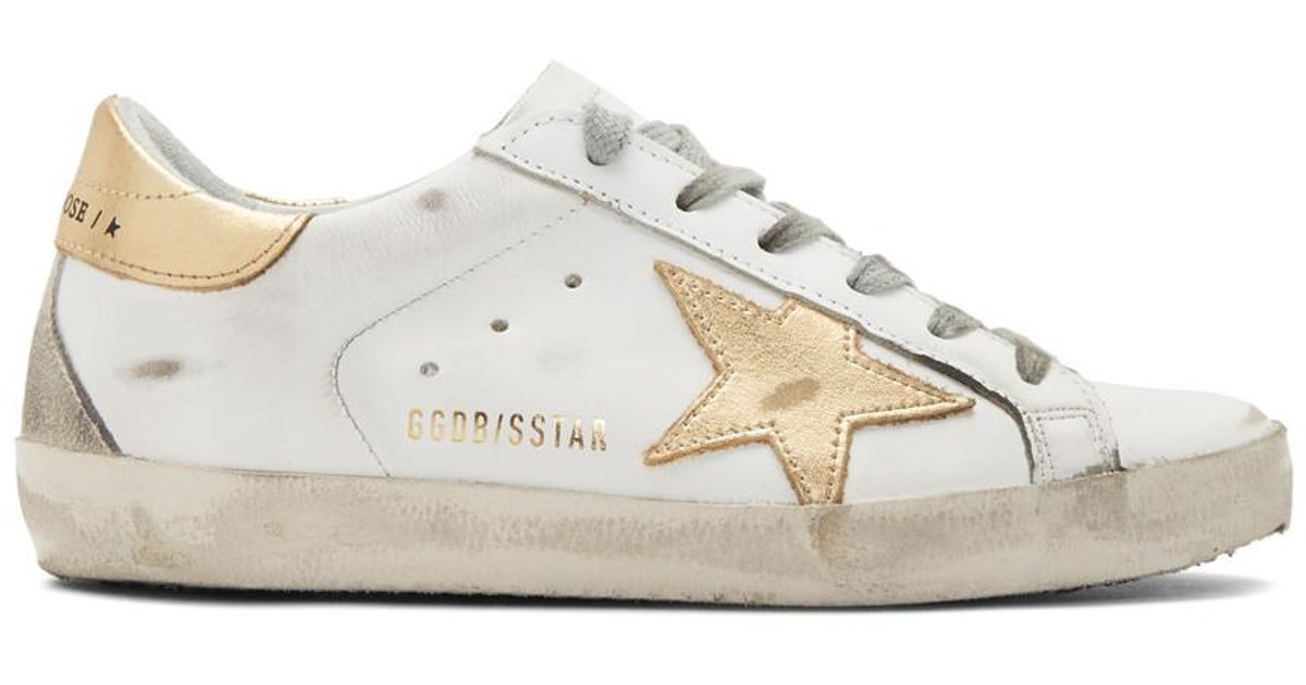 white and gold golden goose sneakers