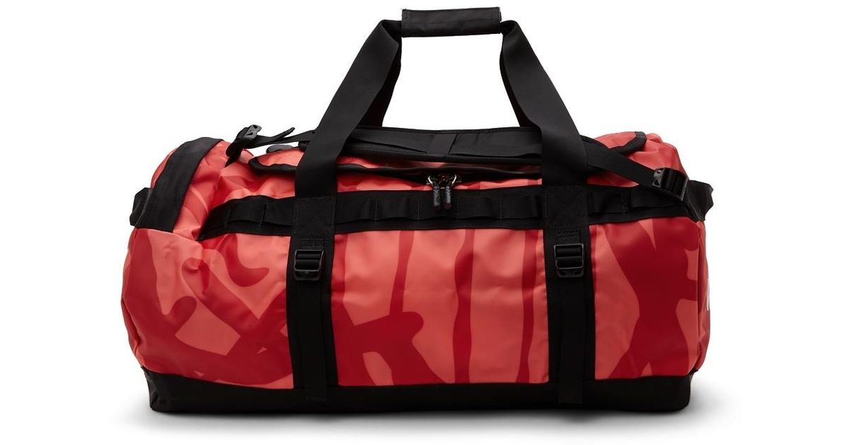 The North Face Canvas Kaws Edition Duffle Bag in Red for Men Lyst