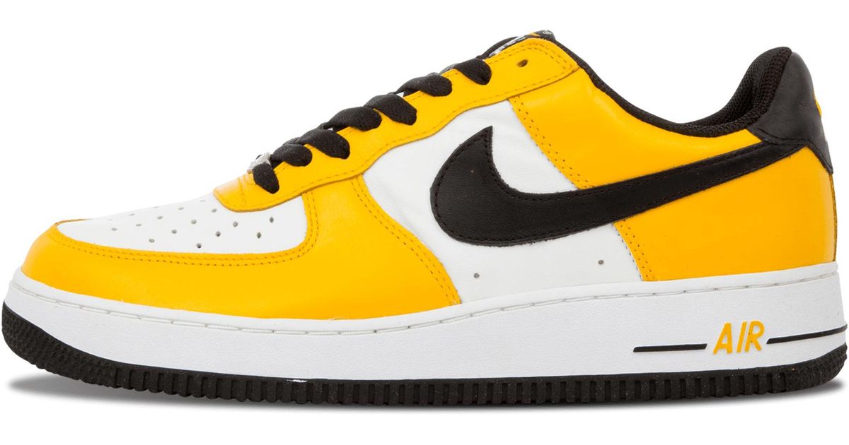 black white and yellow nike shoes