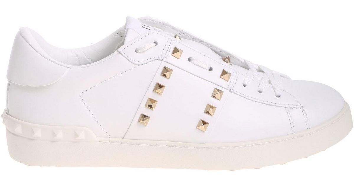 white sneakers with gold studs