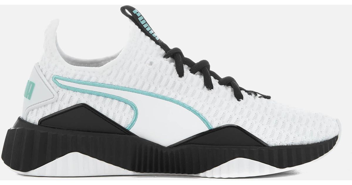 puma defy trainers in white