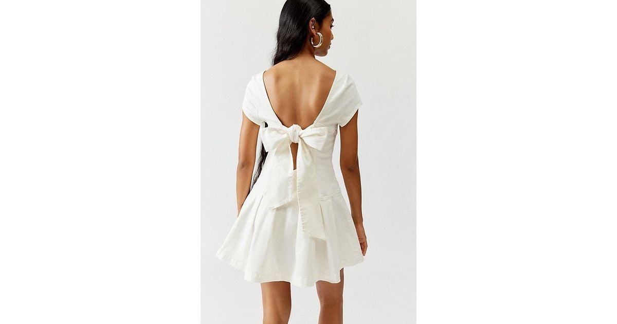 Urban Outfitters Uo Bryan Bow-Back Pleated Drop Waist Denim Mini Dress in  White | Lyst