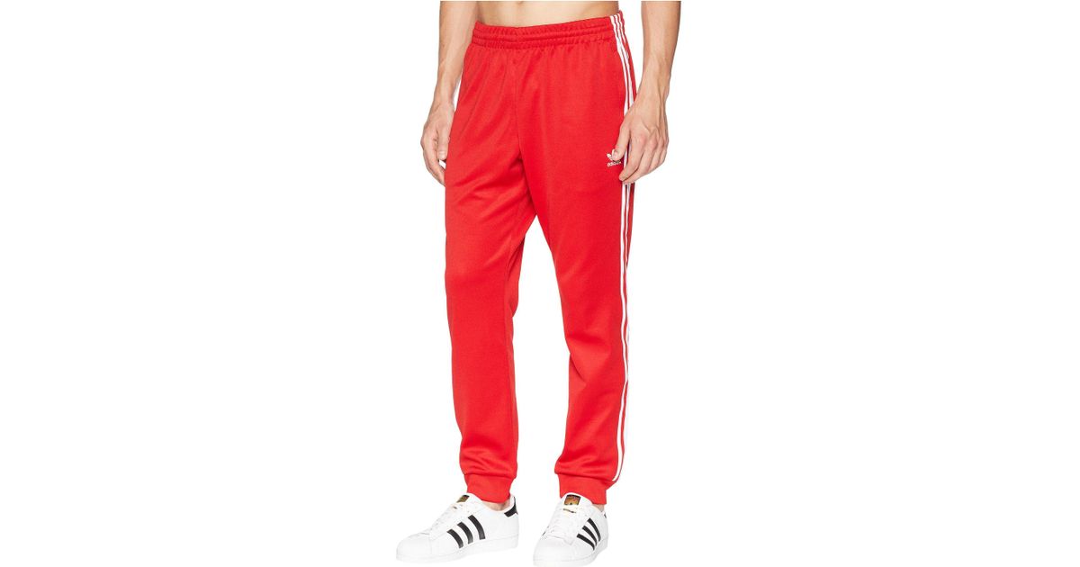 adidas sst track pants red