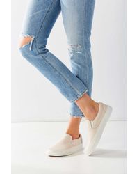 cream slip on vans