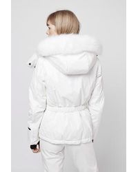 white snow jacket with fur hood