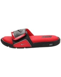 white and red fluffy nike slides
