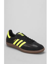 black and yellow adidas samba