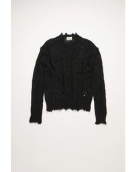 frayed black sweater