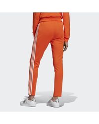 adidas Sst Trainingsbroek in het Oranje - Lyst
