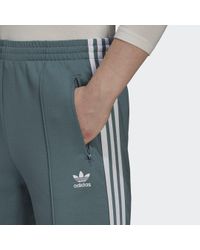 adidas Katoen Primeblue Sst Trainingsbroek in het Groen - Lyst