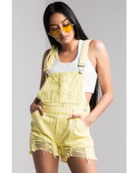 yellow baggy overalls