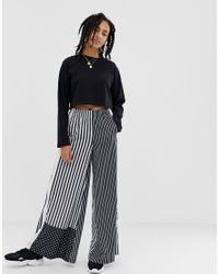 Pantaloni bianchi e neri con strisce e bottoni a pressioneadidas Originals  in Materiale sintetico di colore Nero | Lyst