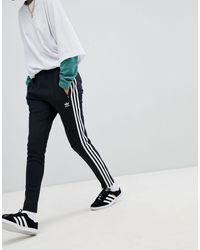adidas originals three stripe track pant in black