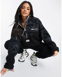 Reebok small logo aztec half zip fleece in black Clearance