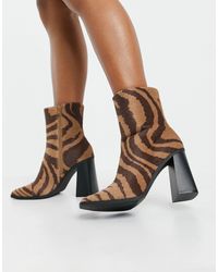 monki zip heeled platform boot in black