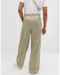 Pantaloni eleganti con fondo ampio in raso lucido olivaASOS in Satin da  Uomo colore Verde | Lyst