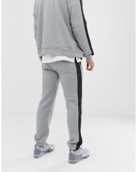 grey nike joggers with black stripe