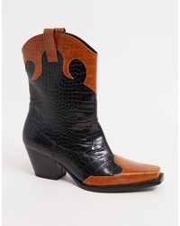 monki zip heeled platform boot in black