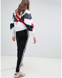 Pantalon de jogging resserr aux chevilles trois bandes Adidas Originals en coloris Black