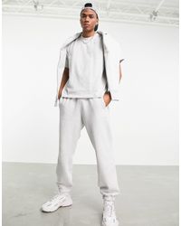 adidas Essentials Warm-Up Tapered 3-Stripes Track Pants - Grey | adidas US