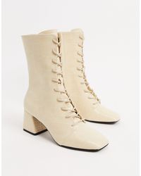 monki zip heeled platform boot in black