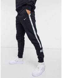 Nike club essentials panelled cuffed joggers in black Clearance