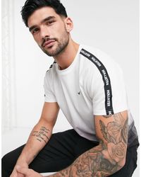 Camiseta en blanco y negro con diseño sombreado y cintas del logo Hollister  de hombre | Lyst