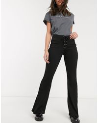 Pantaloni a zampa neri a coste con laccettiBershka in Materiale sintetico  di colore Nero | Lyst