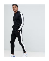Tuta attillata nera con felpa con cappuccio/joggers extreme skinny con riga  laterale bianca da Uomo di ASOS in Nero | Lyst