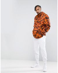 puma pullover windbreaker in camo print in orange exclusive to asos