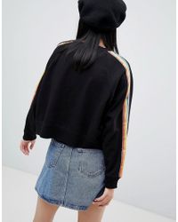 Unique - Sweat-shirt à imprimé arc-en-ciel Monki en coloris Black