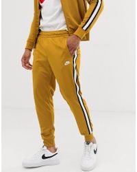 gold nike joggers