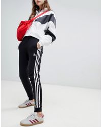 Pantalon de jogging resserr aux chevilles trois bandes Adidas Originals en coloris Black
