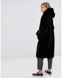 monki faux fur zip hooded coat in black